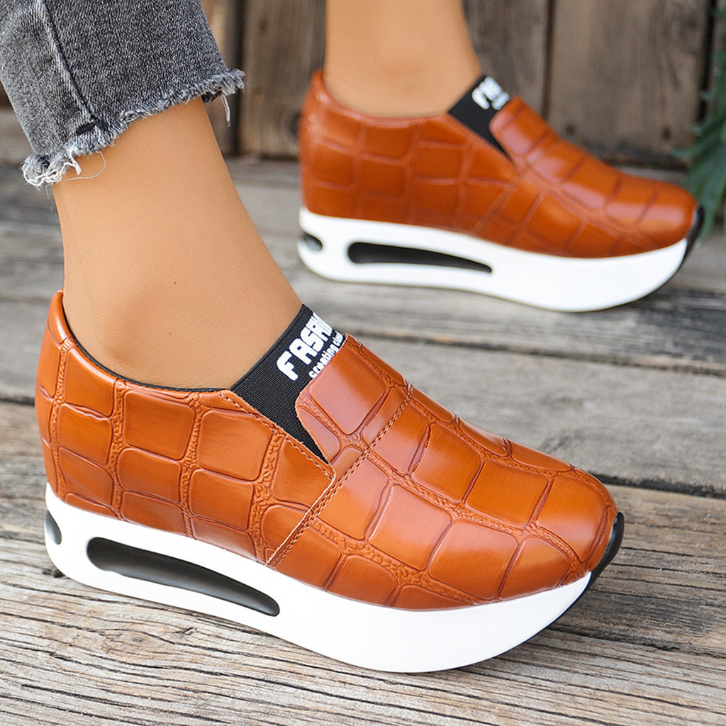 Women's crocodile pattern platform slip-on sneakers by Trendsi, featuring faux leather casual shoes with a stylish crocodile texture.