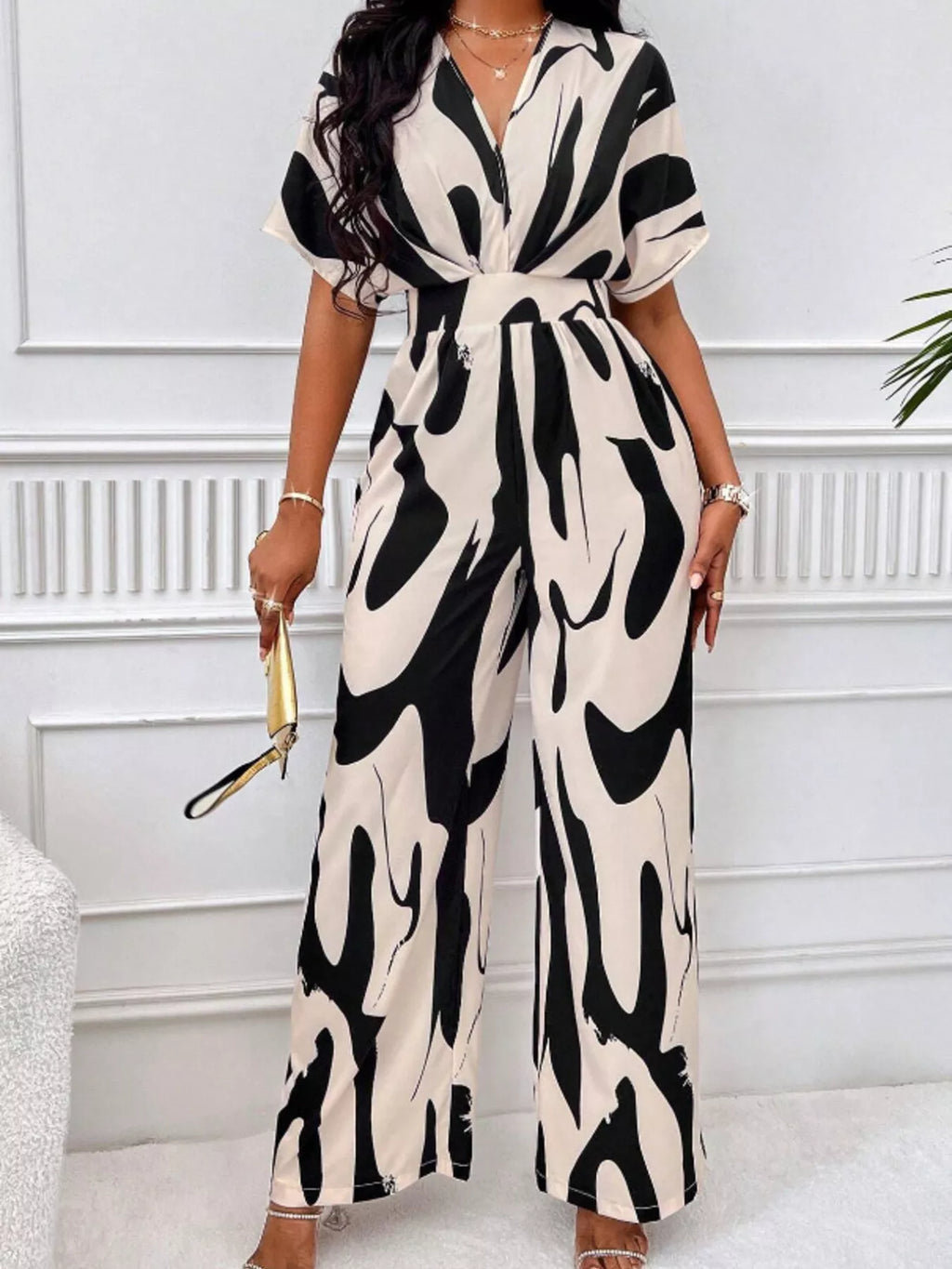 Abstract print wide-leg jumpsuit from Trendsi featuring a stylish, flowing design and bold artistic patterns.