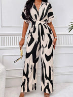 Abstract print wide-leg jumpsuit from Trendsi featuring a stylish, flowing design and bold artistic patterns.