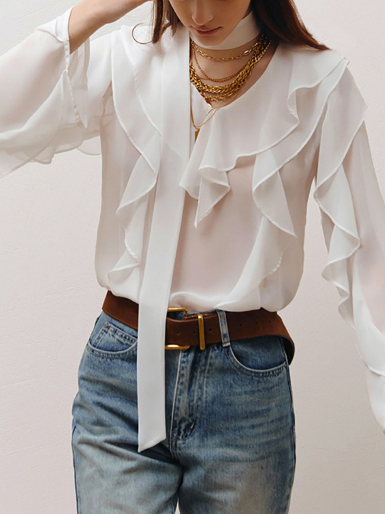 Elegant chiffon blouse with ruffle trim and tie neck detail, stylish blouse by Trendsi featuring flowy fabric and feminine design.