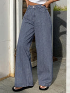 Striped wide-leg jeans by Shopimist featuring a high waist, relaxed fit, and bold vertical stripe pattern on denim fabric.
