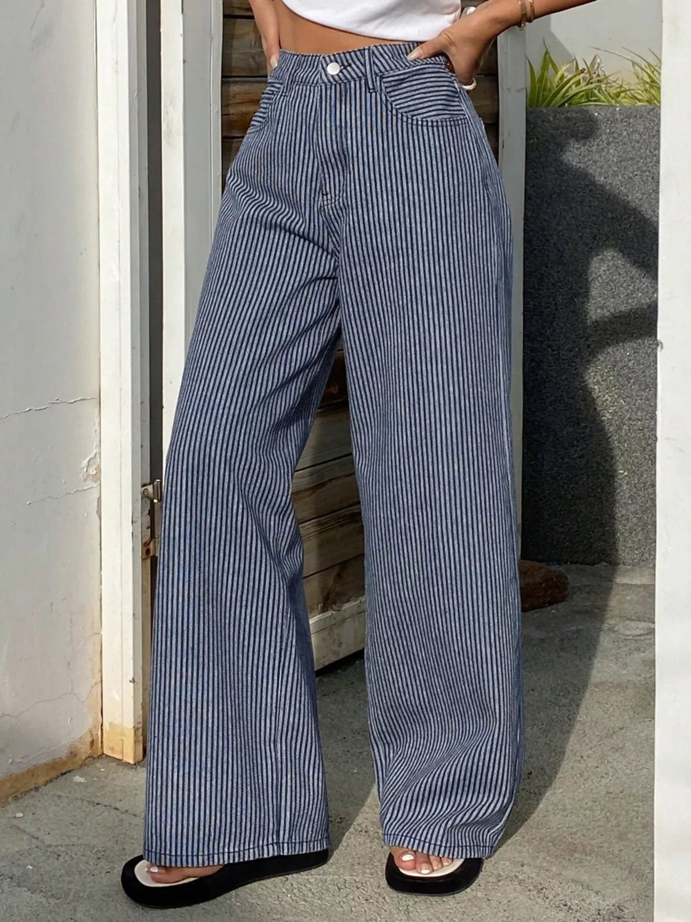 Striped wide-leg jeans by Shopimist featuring a high waist, relaxed fit, and bold vertical stripe pattern on denim fabric.