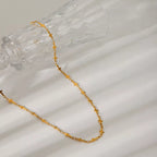 18K gold-plated cross necklace with delicate chain, showcasing a shiny, polished finish and classic religious pendant.