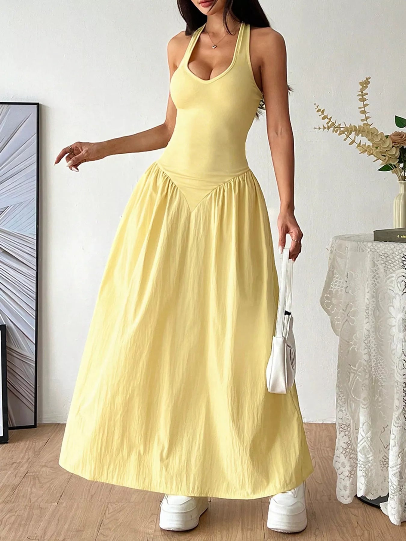 Halter neck ruched maxi dress by Plush Fashion Hub, featuring a flowing silhouette and gathered fabric details.