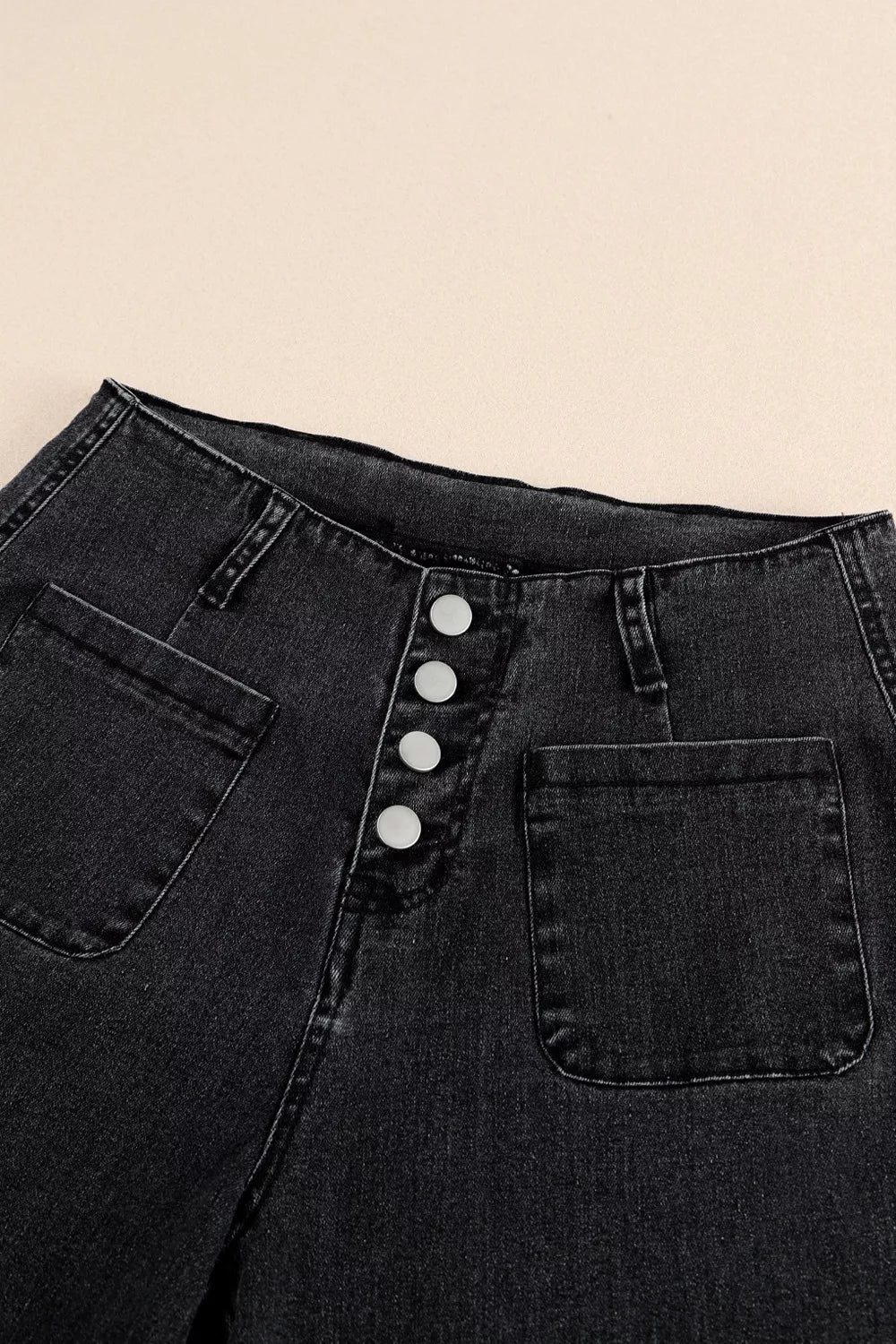 High-waisted button-fly wide-leg jeans by Trendsi, showcasing denim fabric, button closure, and relaxed fit with wide-leg style.