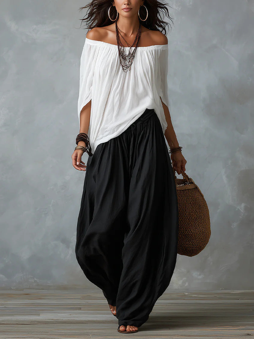 Women's one-shoulder t-shirt and wide-leg pants two-piece set from Plush Fashion Hub, urban casual outfit, shown on a model.