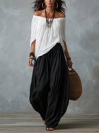 Women's one-shoulder t-shirt and wide-leg pants two-piece set from Plush Fashion Hub, urban casual outfit, shown on a model.