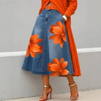 Women's floral print denim-style A-line midi skirt by FitiqueFit featuring boho-inspired design and flowy silhouette.