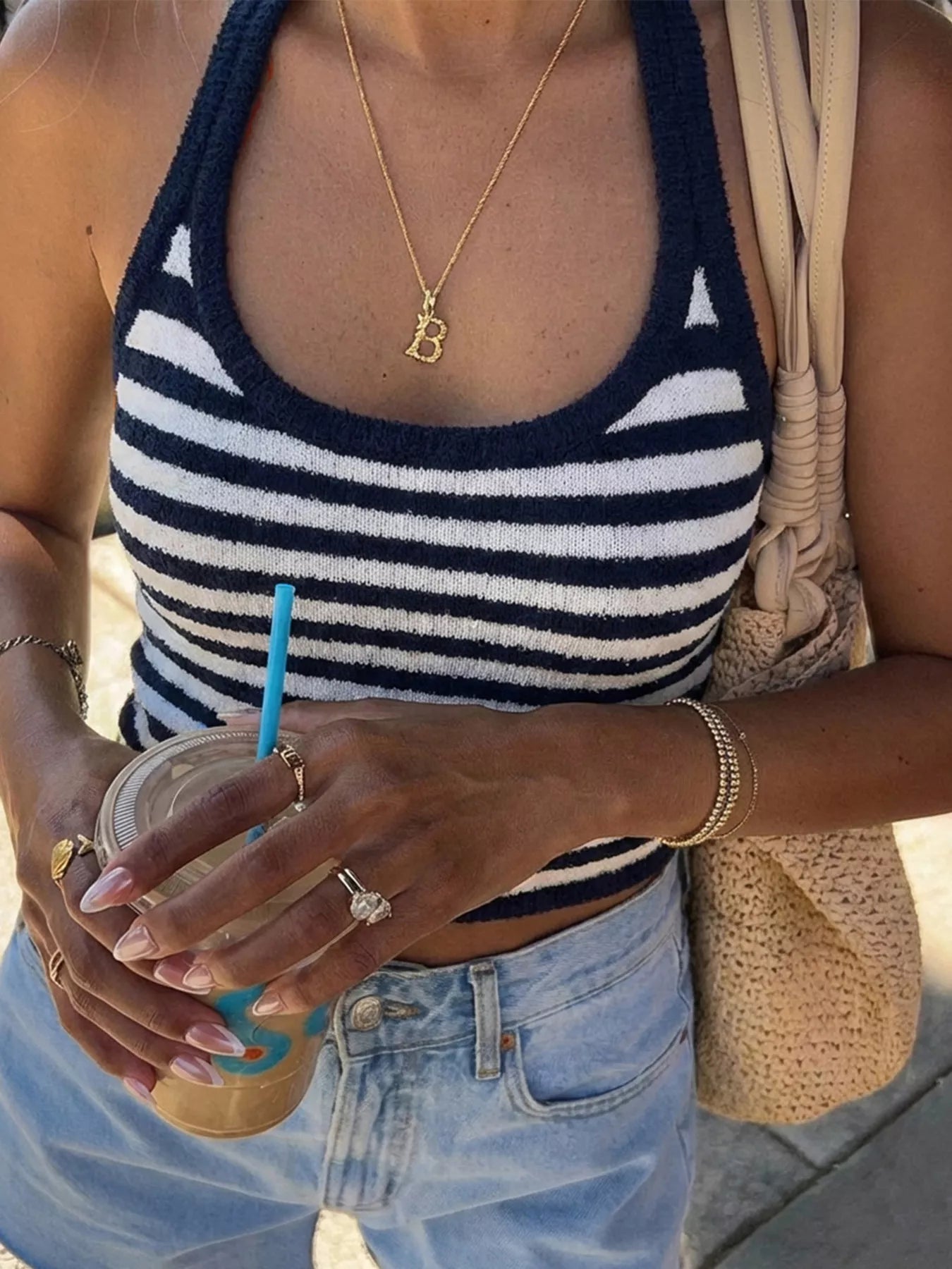 Striped halter neck cami top from Trendsi featuring bold vertical stripes and a stylish halter neckline.