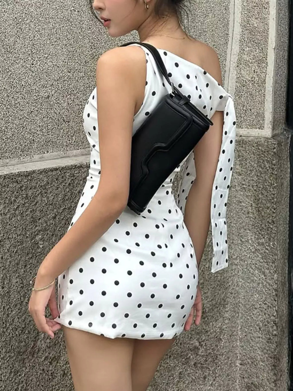 Polka dot sleeveless mini dress with bow accents by Shopimist, featuring a playful pattern and stylish design.