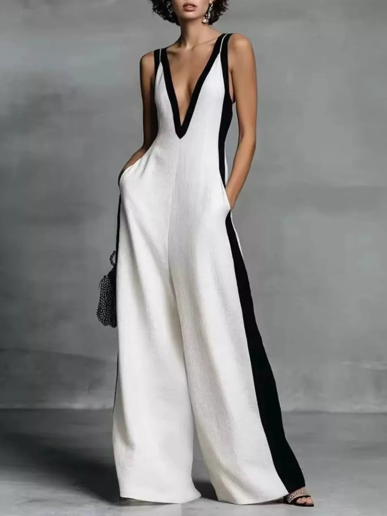 Deep V-neck wide-leg jumpsuit by Plush Fashion Hub featuring a stylish onesie design in soft fabric with a relaxed fit.