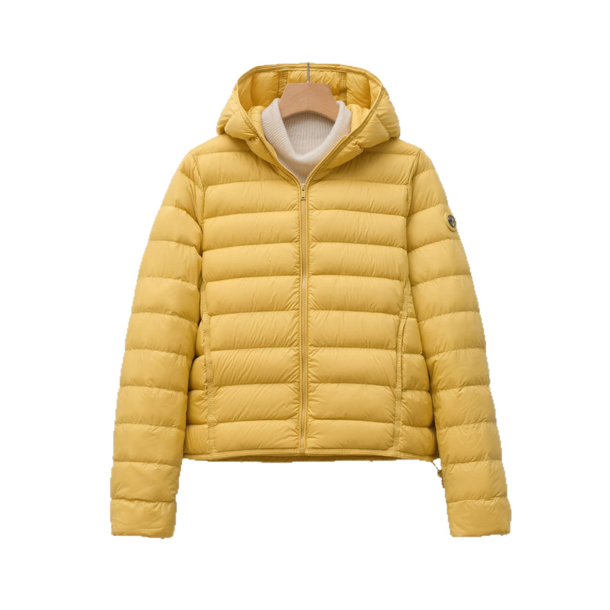 Yellow hooded puffer jacket with a quilted nylon design, zip-up front, and a white sweater underneath.