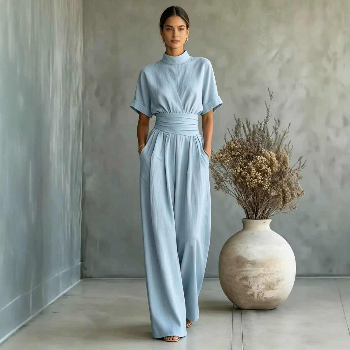 Eprolo half high neck short sleeve wide-leg jumpsuit displayed on a hanger, showcasing the stylish design and fabric texture.
