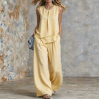 Women's sleeveless two-piece set by FitiqueFit featuring solid color wide-leg pants and matching sleeveless top.