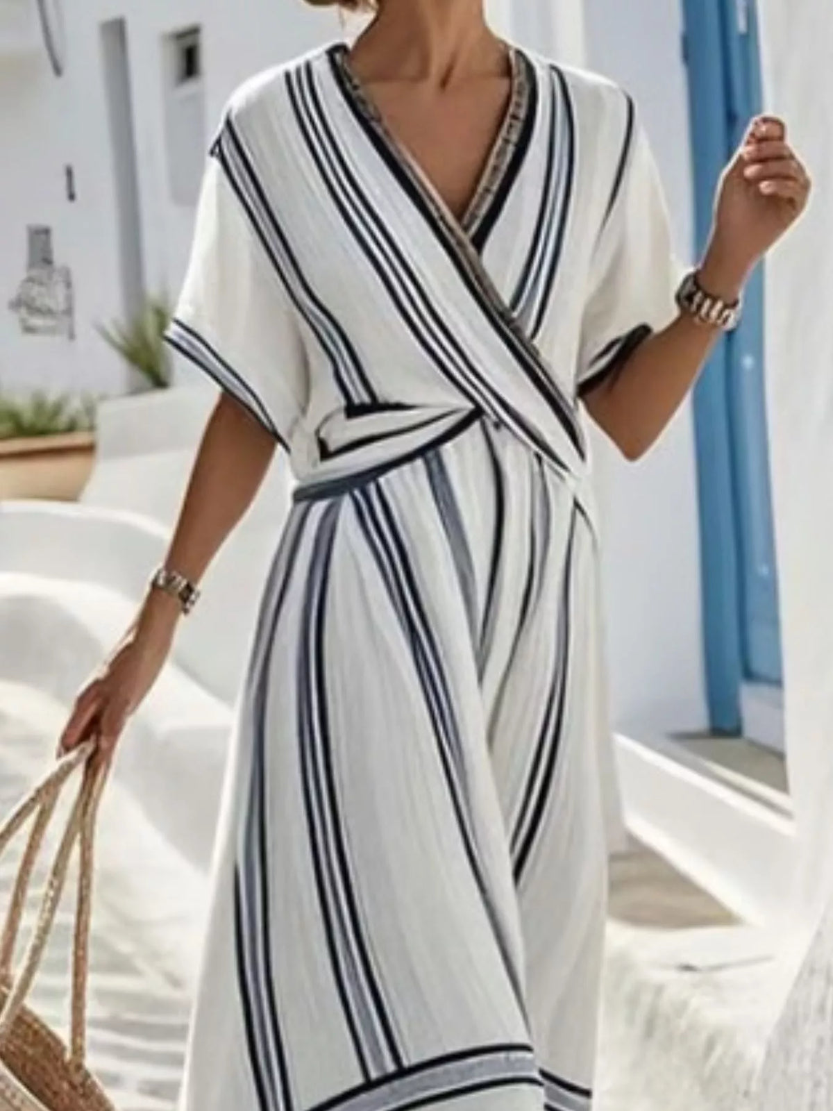 Plus size striped short sleeve wrap maxi dress by Trendsi, featuring a stylish full-length design with a fitted waist and flowing skirt.