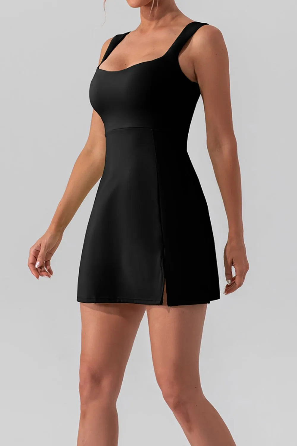 Square neck sleeveless slit mini active dress by Trendsi, shown in black with a fitted silhouette and stylish slit detail.