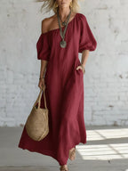 One-shoulder puff sleeve maxi dress by Trendsi featuring a flowing silhouette and elegant design.