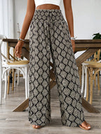 Women's printed wide-leg tie-waist pants by Trendsi, lightweight high-waist trousers with a relaxed fit and stylish pattern.