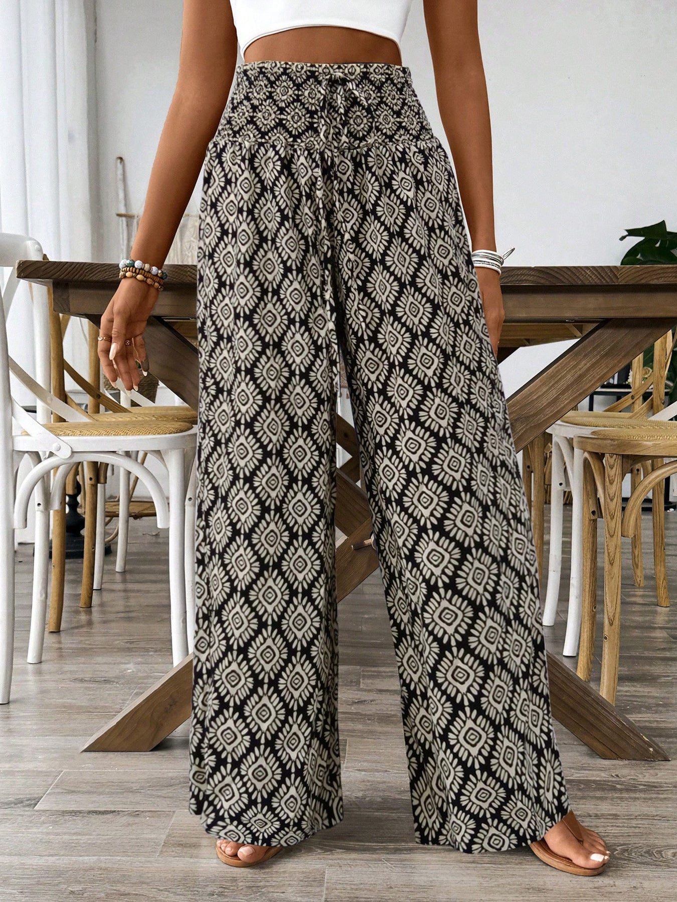 Women's printed wide-leg tie-waist pants by Trendsi, lightweight high-waist trousers with a relaxed fit and stylish pattern.
