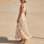 Women's halterneck high-waist swing dress by FitiqueFit featuring floral and solid print casualwear, shown with a flowing skirt.