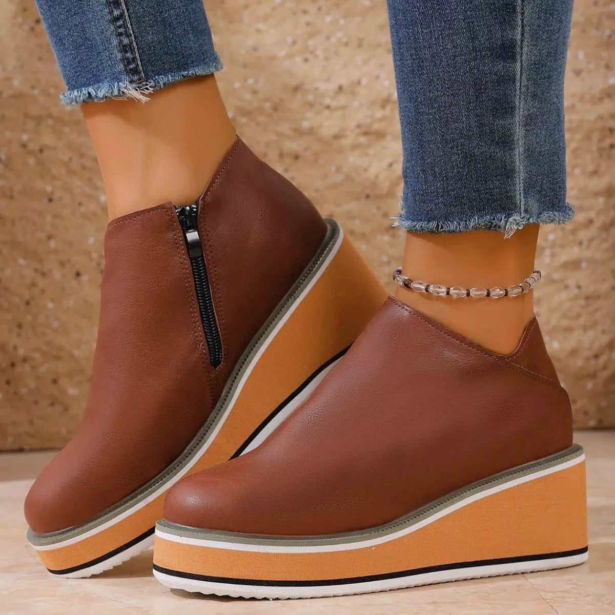 Women's round toe wedge ankle boots by Trendsi featuring classic design, ankle height, and stylish wedge heel.
