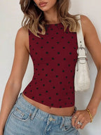 Polka dot tank top by Shopimist featuring a sleeveless design and playful black and white polka dot pattern.