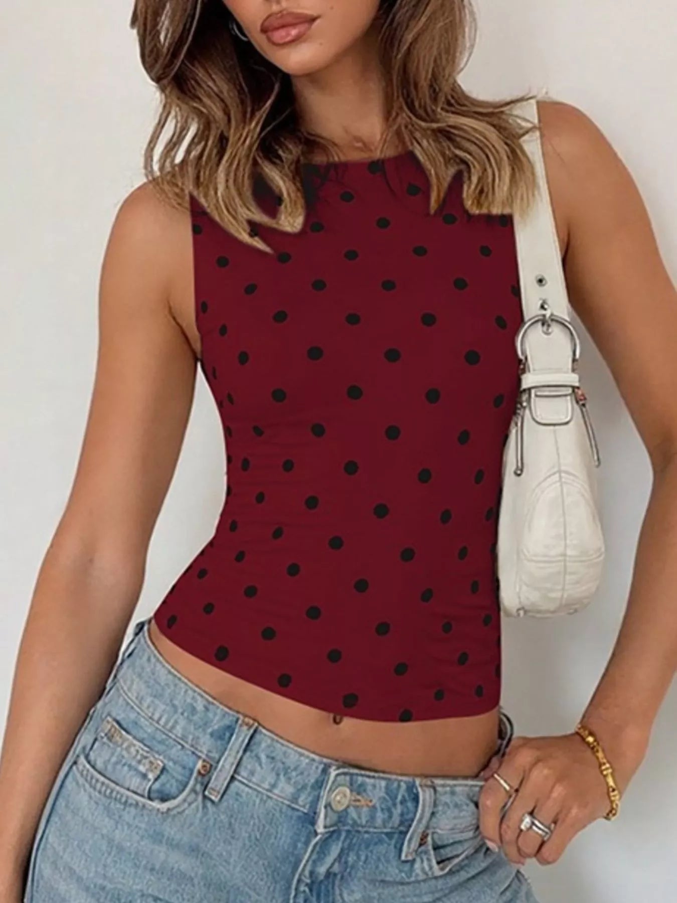 Polka dot tank top by Shopimist featuring a sleeveless design and playful black and white polka dot pattern.