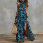 Women's printed boho maxi dress by FitiqueFit featuring sleeveless design, split front, loose fit, and vibrant pattern.