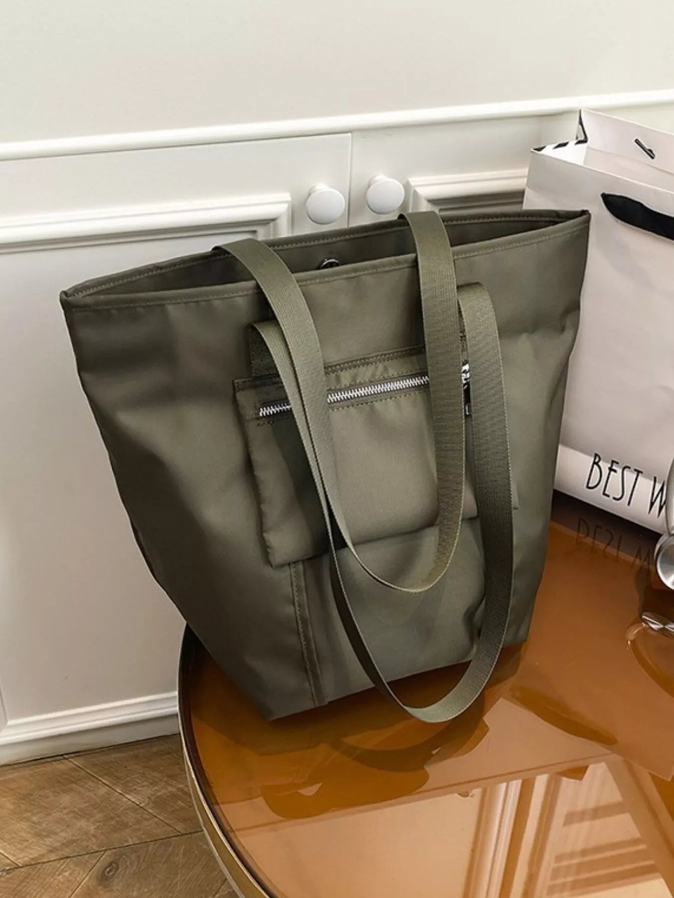 Casual lightweight nylon shoulder bag in neutral color, branded Plush Fashion Hub, featuring adjustable strap and spacious interior.