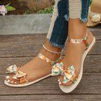 Trendsi floral bowknot ankle strap flat sandals for women, summer shoes with comfortable slip-on design and floral embellishments.