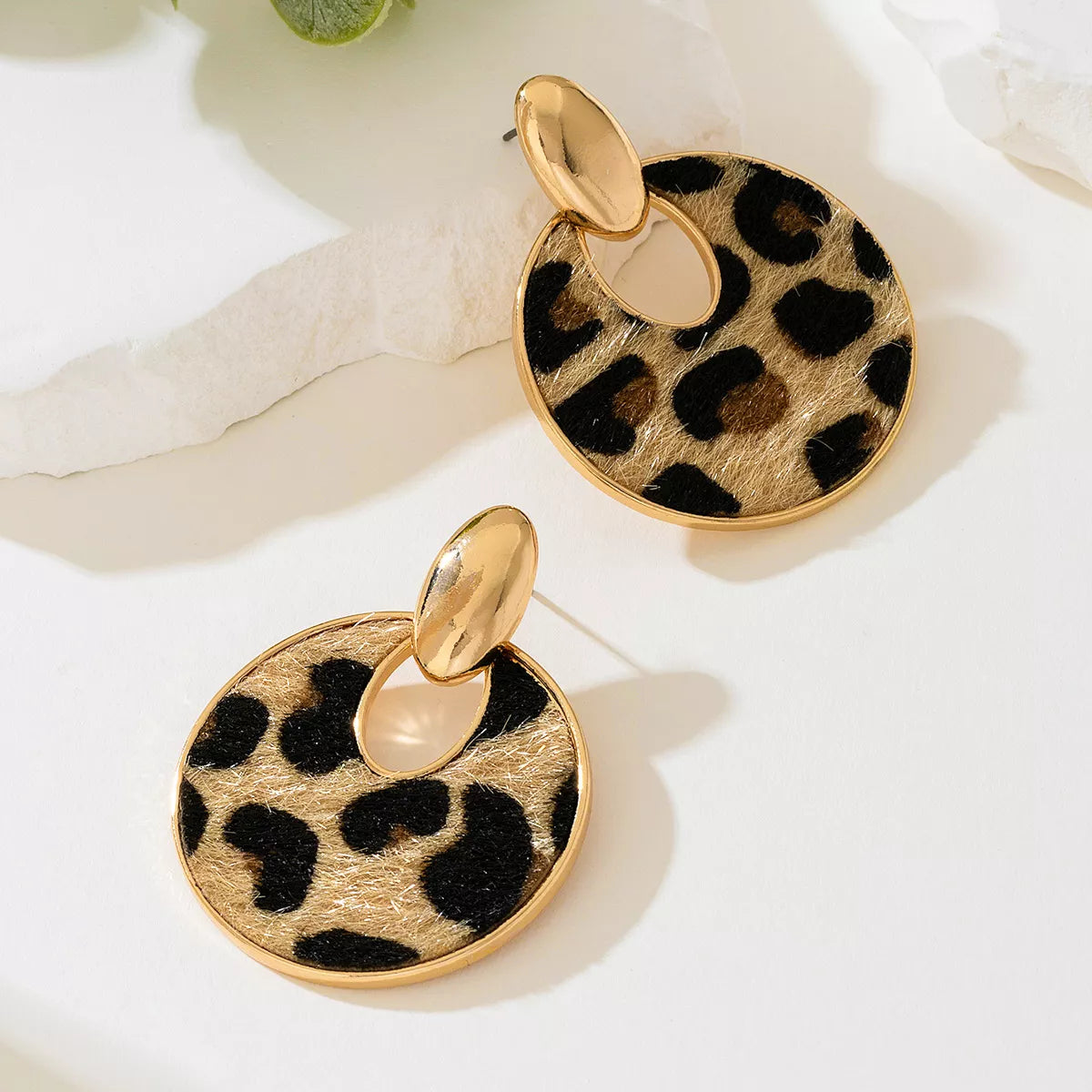 Leopard print circle dangle earrings from Plush Fashion Hub featuring gold-tone hooks and bold animal print design.