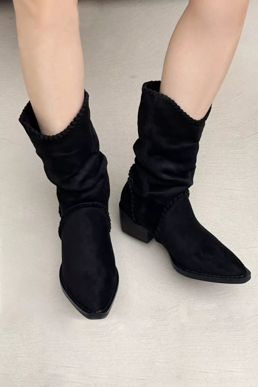 Point toe block heel boots in black leather with sleek design, stylish footwear from Trendsi showing side view.