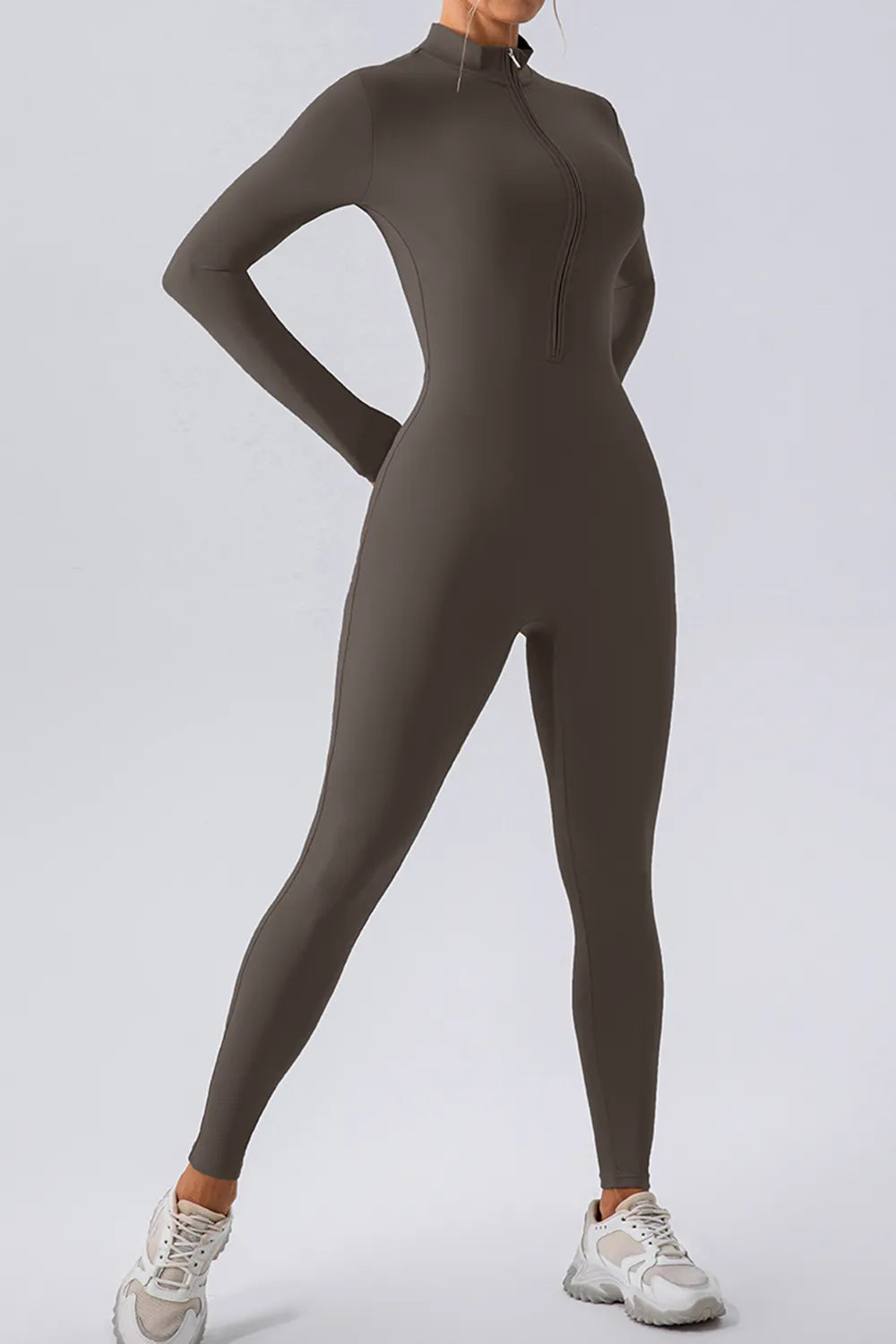 Trendsi half zip mock neck active jumpsuit in sleek athletic wear style, featuring a fitted design and comfortable fabric.