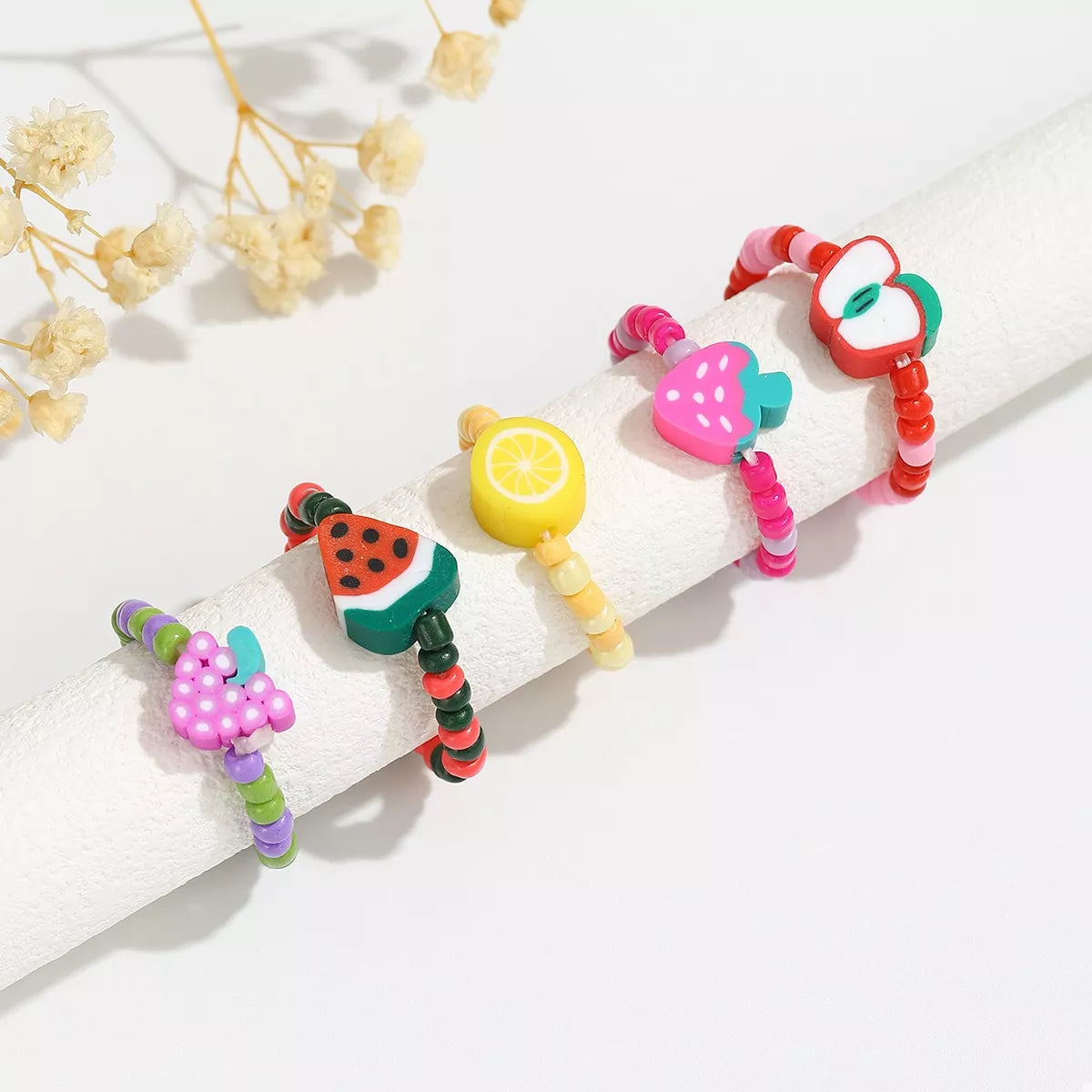 Colorful fruit charm beaded ring from Plush Fashion Hub featuring vibrant beads and playful fruit motifs.