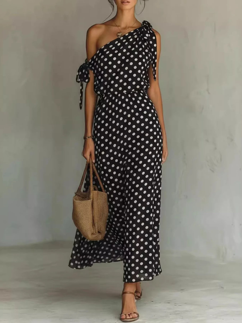 Plus size polka dot one-shoulder maxi dress by Trendsi, featuring a full-length dress with a stylish one-shoulder design and vibrant polka dots.