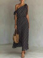 Plus size polka dot one-shoulder maxi dress by Trendsi, featuring a full-length dress with a stylish one-shoulder design and vibrant polka dots.