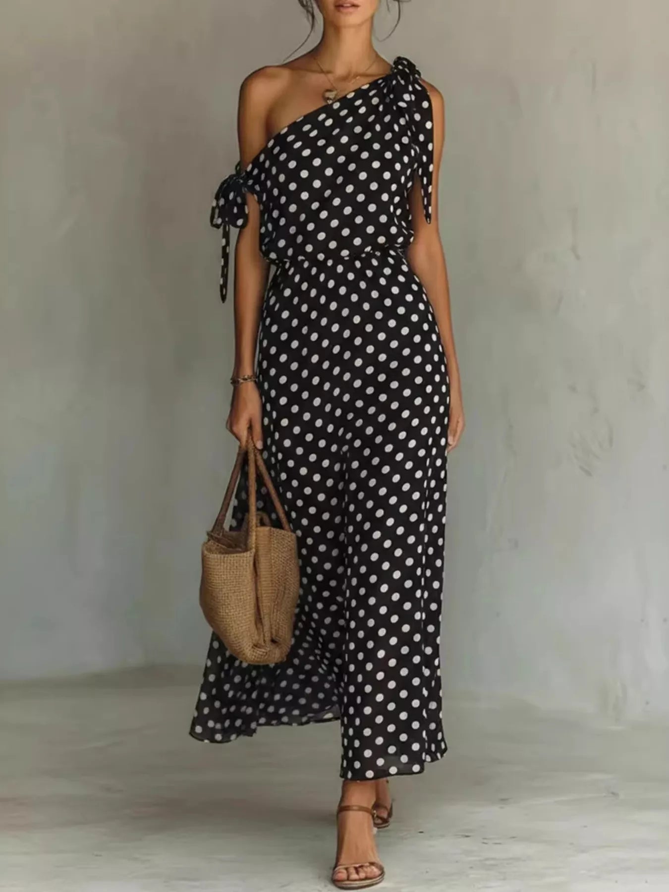 Plus size polka dot one-shoulder maxi dress by Trendsi, featuring a full-length dress with a stylish one-shoulder design and vibrant polka dots.