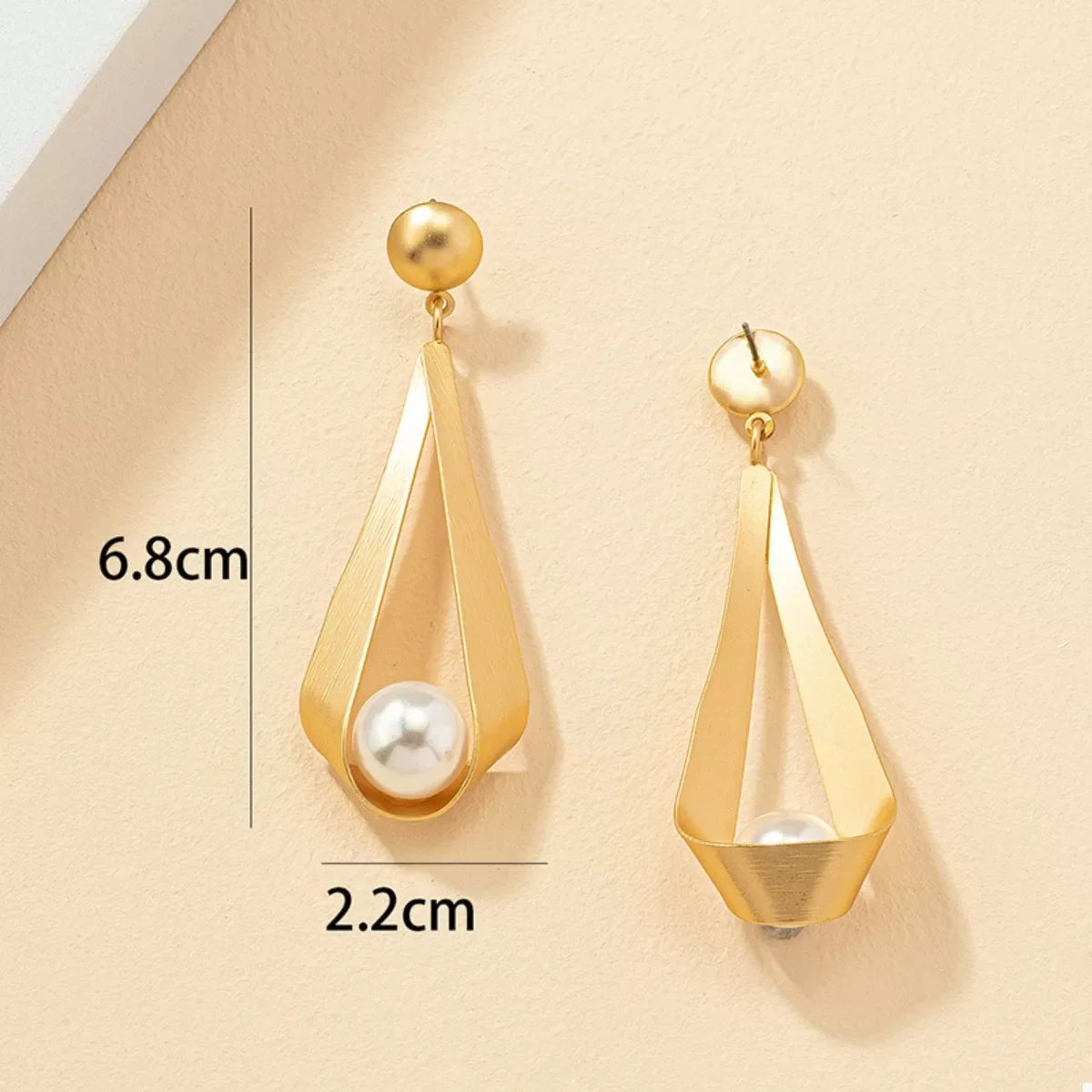 18K gold-plated pearl drop earrings with elegant dangling pearls, featuring a sleek and shiny gold finish.