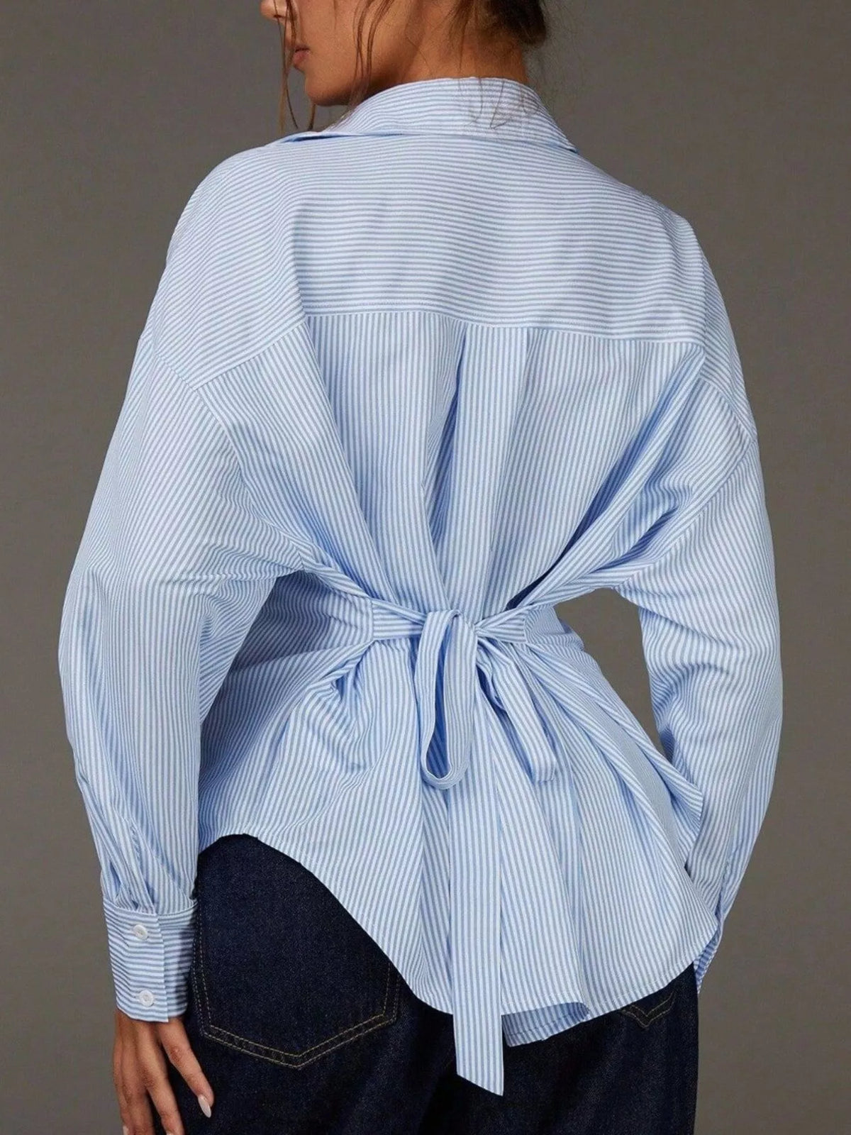 Casual striped button-down shirt by Trendsi featuring a classic collar, long sleeves, and a relaxed fit in various colors.