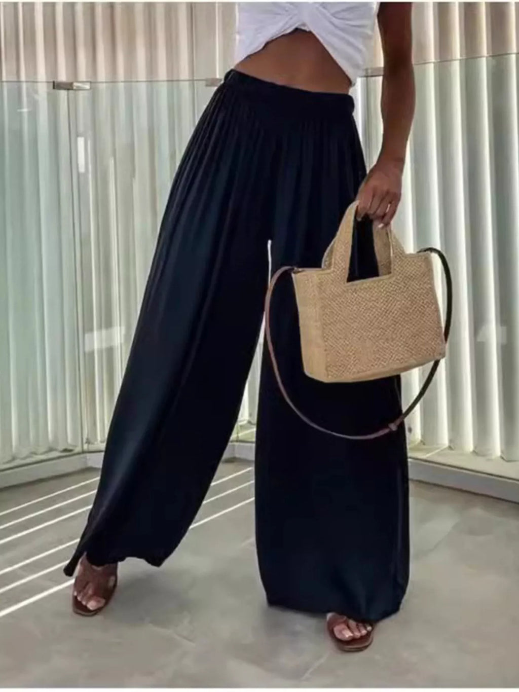 Wide-leg flowy pants from Trendsi, showing soft, lightweight fabric with a relaxed fit, high waist, and full-length design.