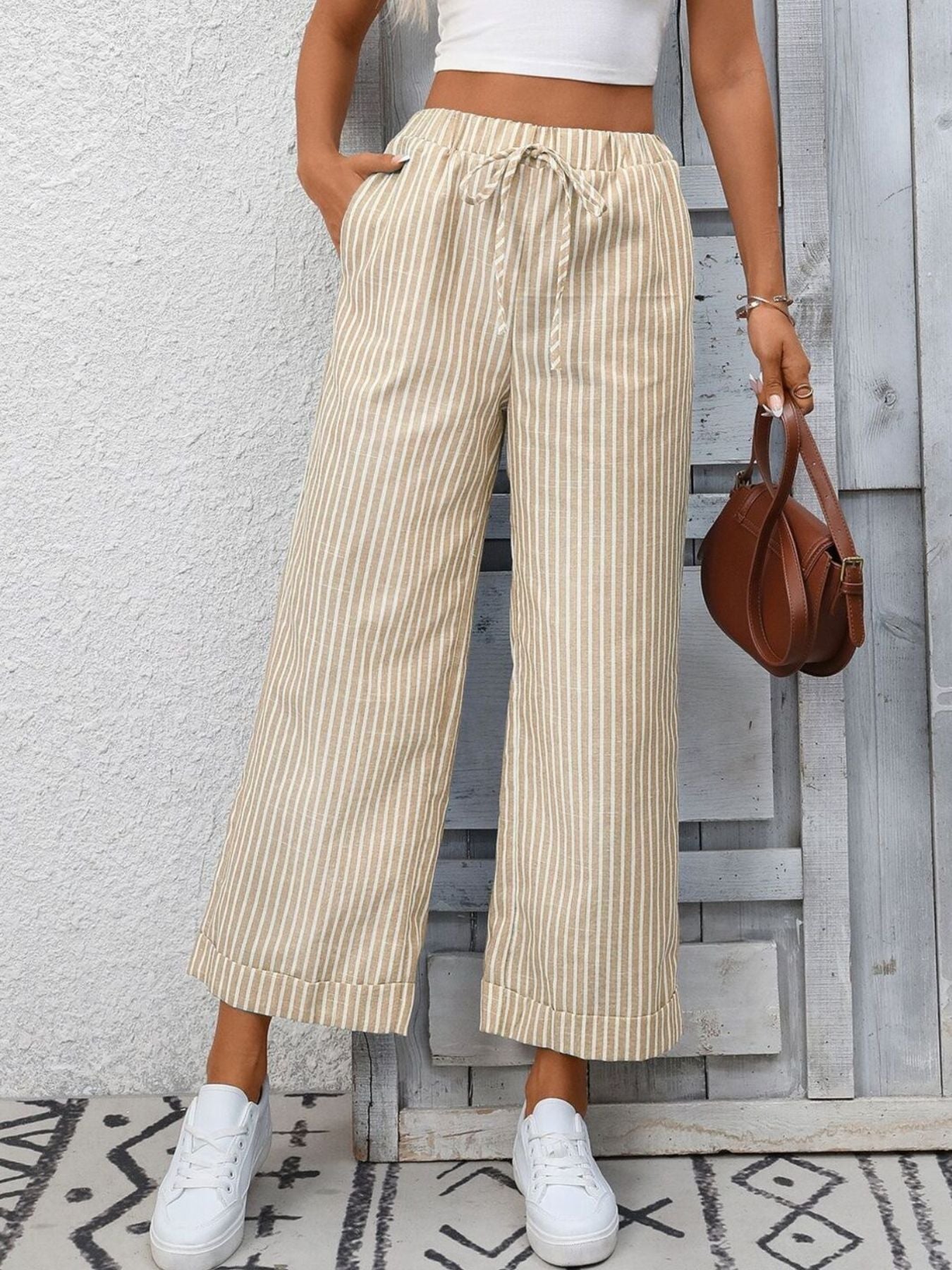 Women's striped wide-leg drawstring pants with pockets from Trendsi, featuring a relaxed fit and casual style.