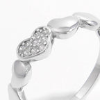 Sterling silver heart ring with inlaid zircon stones, elegant jewelry piece showcasing a sparkling design and fine craftsmanship.