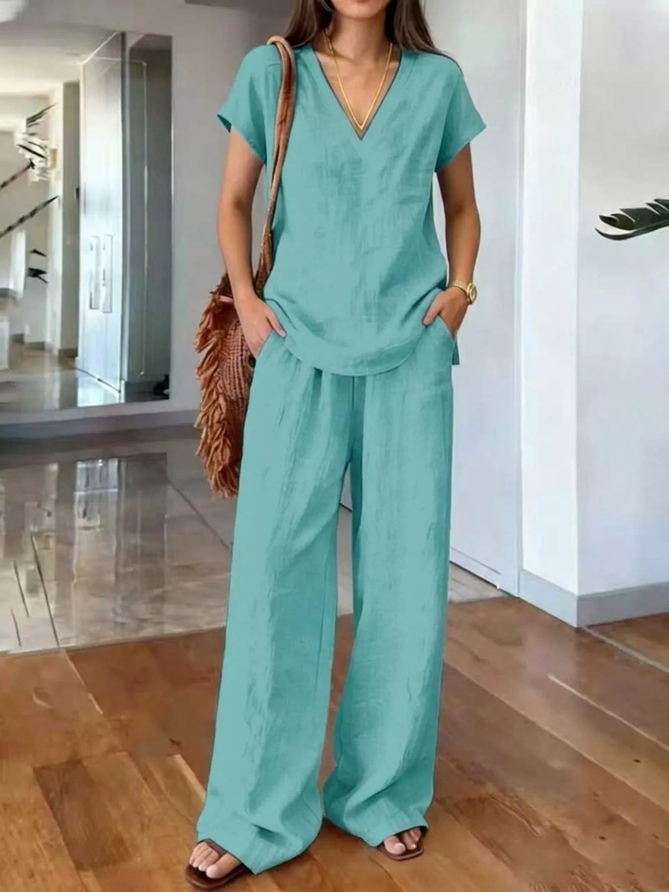 Plus size Trendsi loungewear set featuring a V-neck short sleeve top and matching pants, comfortable and casual for relaxed wear.