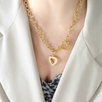 Titanium steel heart pendant necklace with a polished finish, featuring a sleek and modern design.