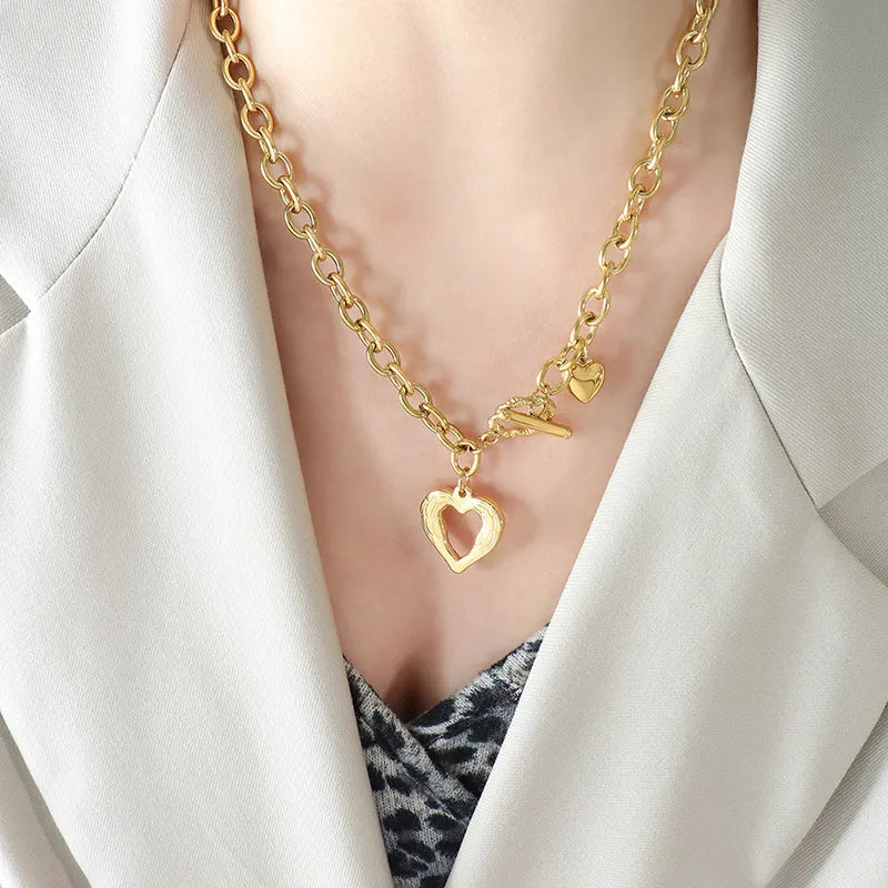 Titanium steel heart pendant necklace with a polished finish, featuring a sleek and stylish design by Plush Fashion Hub.