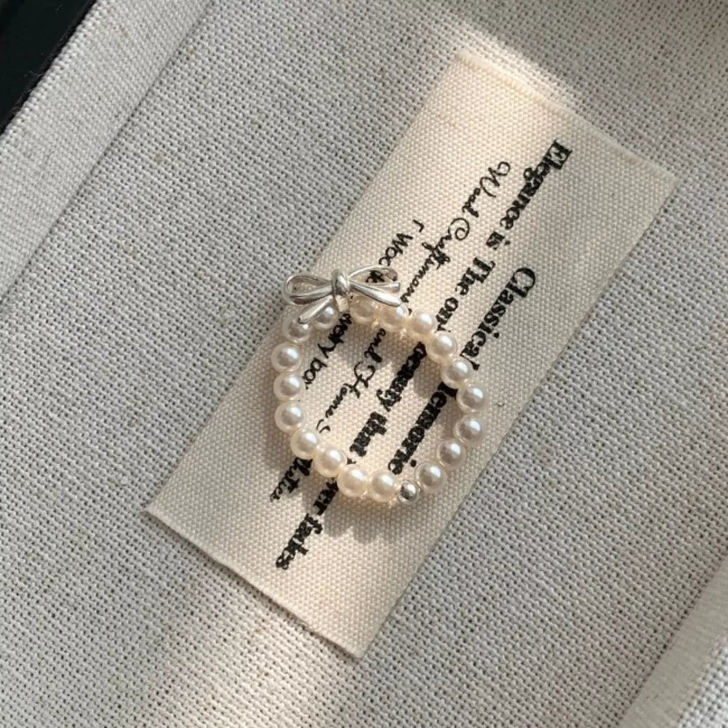 Shopimist bow pearl beaded ring featuring a delicate design with pearls and beaded accents on a silver band.