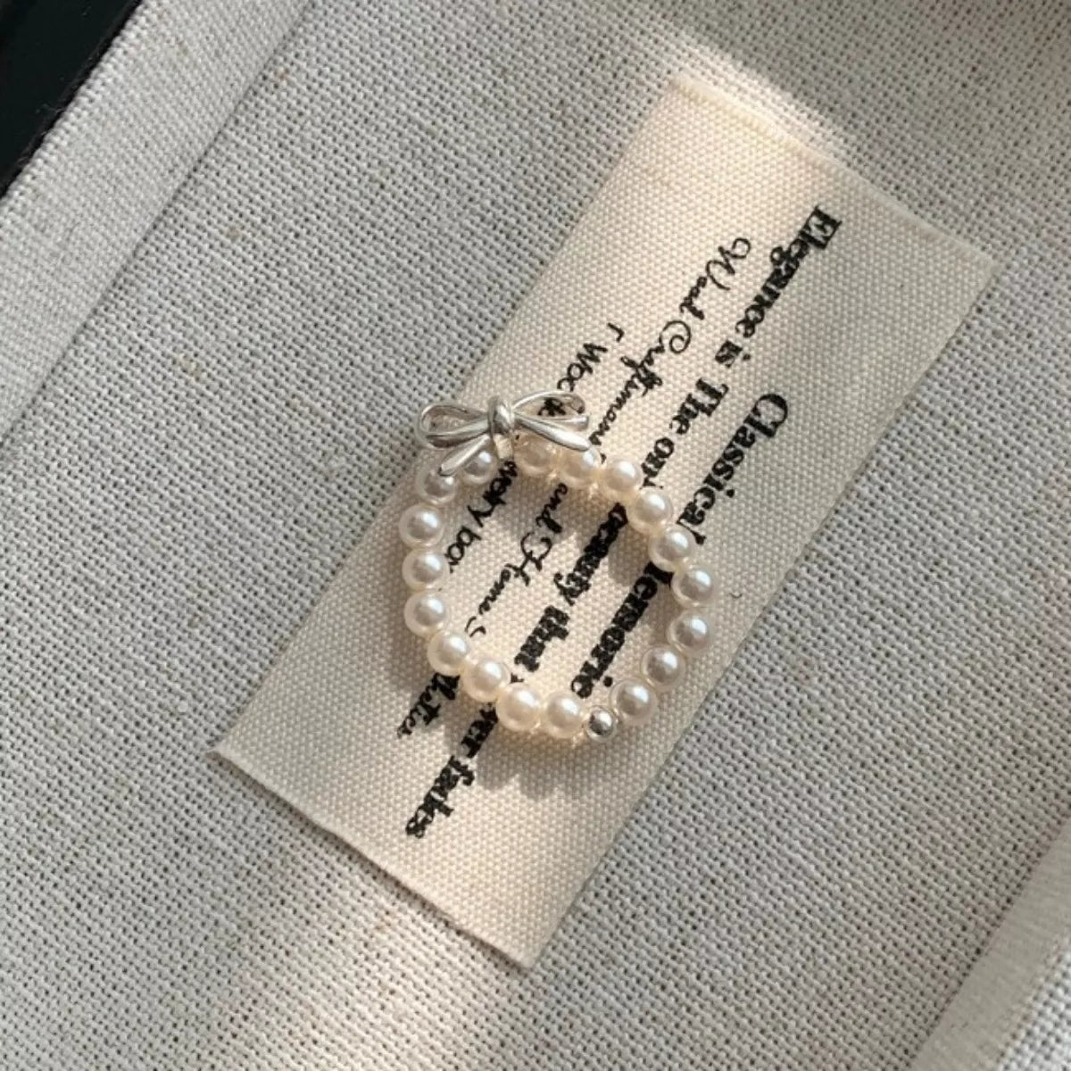 Shopimist bow pearl beaded ring featuring a delicate design with pearls and beaded accents on a silver band.