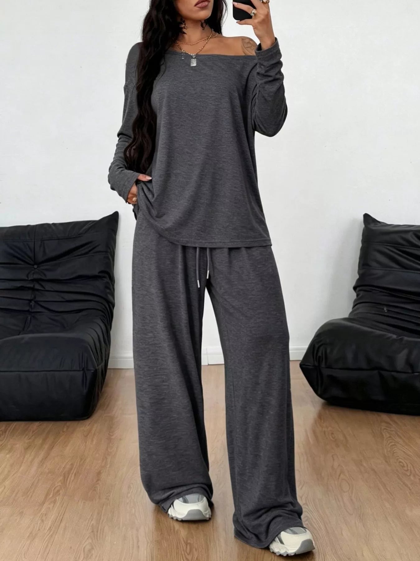 Plus size loose fit one-shoulder T-shirt and pants set by Trendsi, featuring comfortable, relaxed fit and casual style.