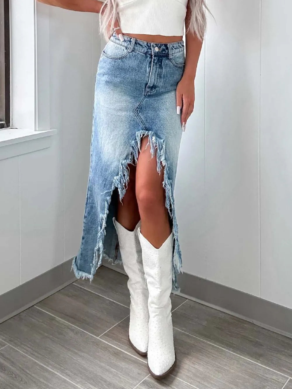 High-waist raw hem asymmetrical denim skirt by Trendsi, featuring distressed denim with uneven hem and stylish fit.