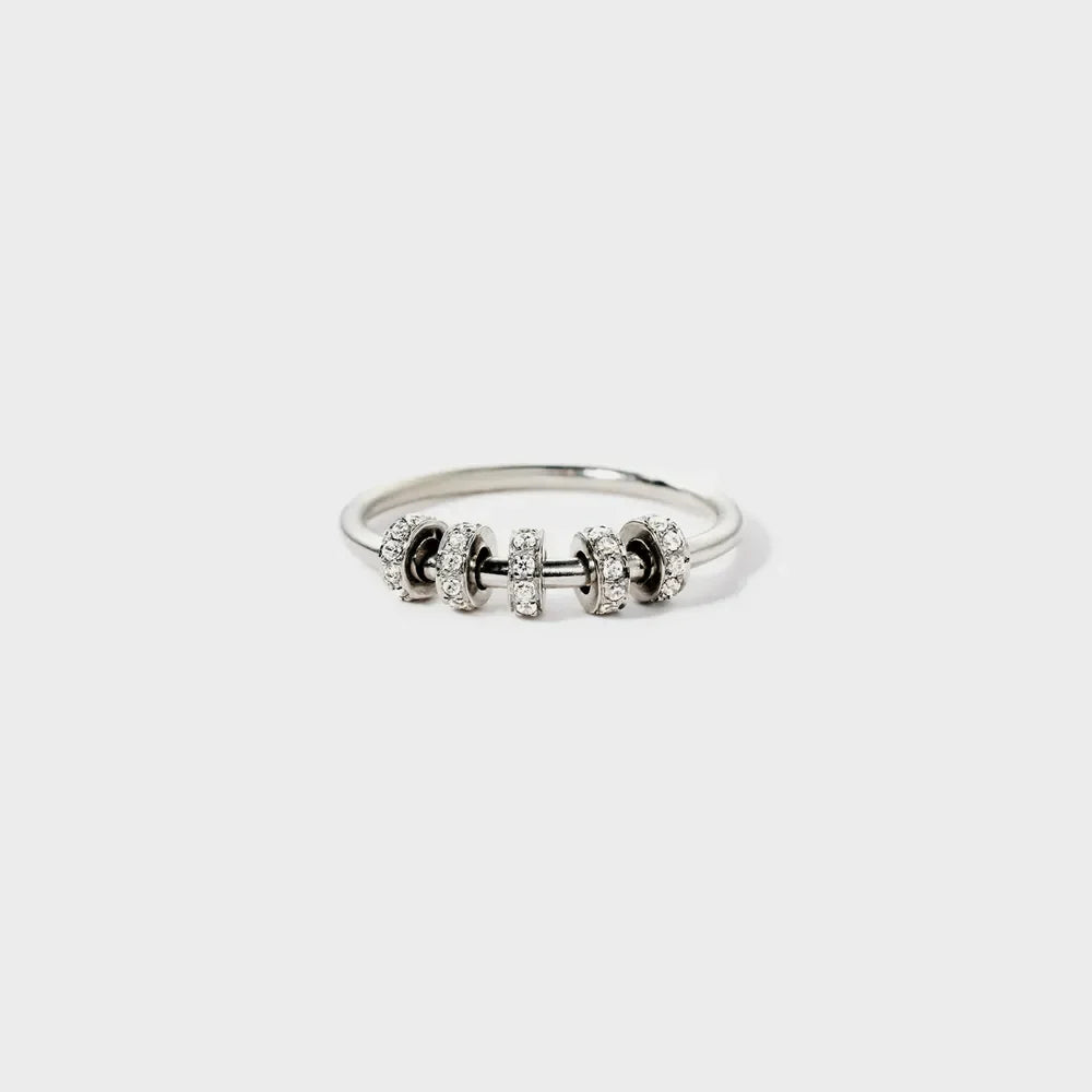 Sterling silver ring with inlaid zircon stones, crafted by Shopimist, showcasing a detailed design and sparkling gemstone accents.